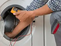 Washing machine repair technician testing a front-load washer with diagnostic tools in Los Angeles, CA